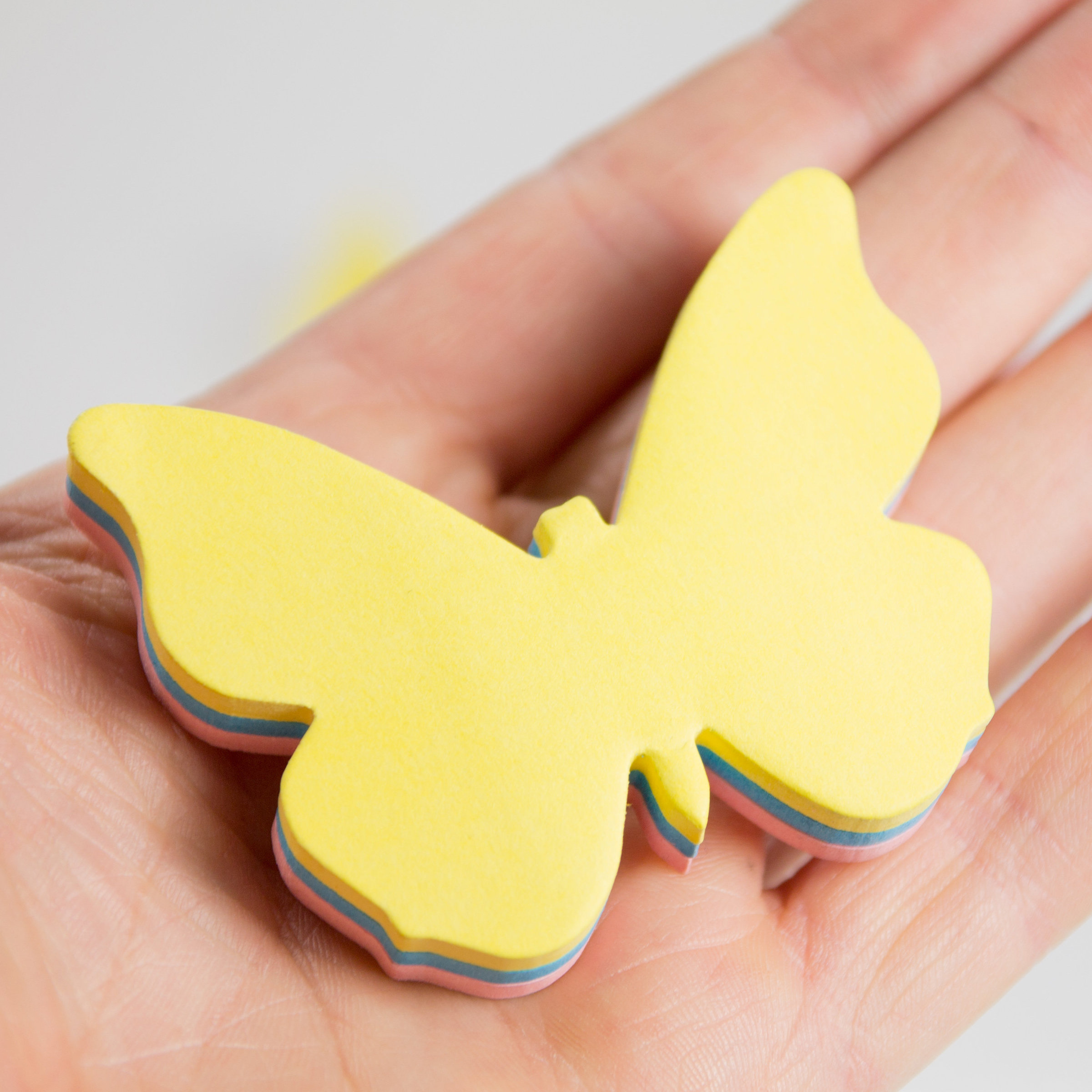 Butterfly sticky note pads in a hand