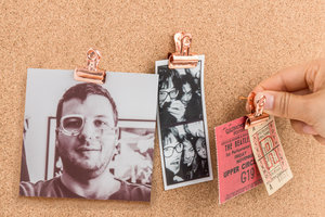 push pin with clips with photographs and tickets