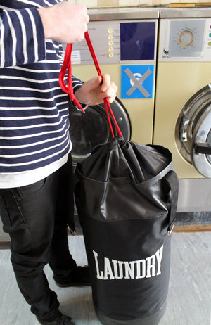 man opening boxing laundry bag