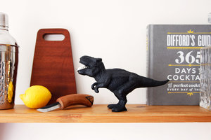 cast iron dinosaur bottle opener with cocktail shaker and chopping board