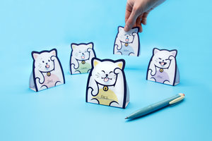 Folded lucky cat memo notes with hand