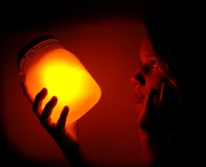 girl holding solar jar in the dark