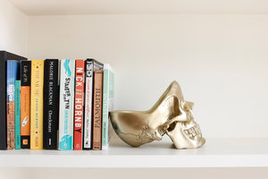 gold skull tidy bookend for shelf