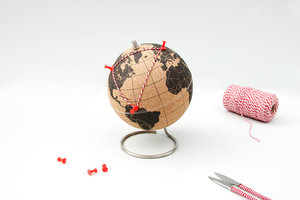 large cork globe with pins and thread