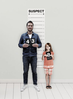 Father and daughter posing for a height chart photo