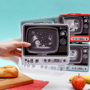 Hand holding tin TV Lunchbox with moving image