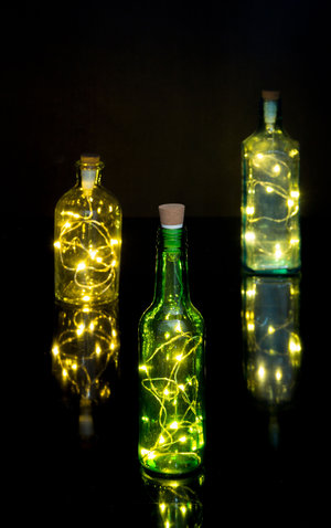 LED String lights displayed in colourful glass bottles