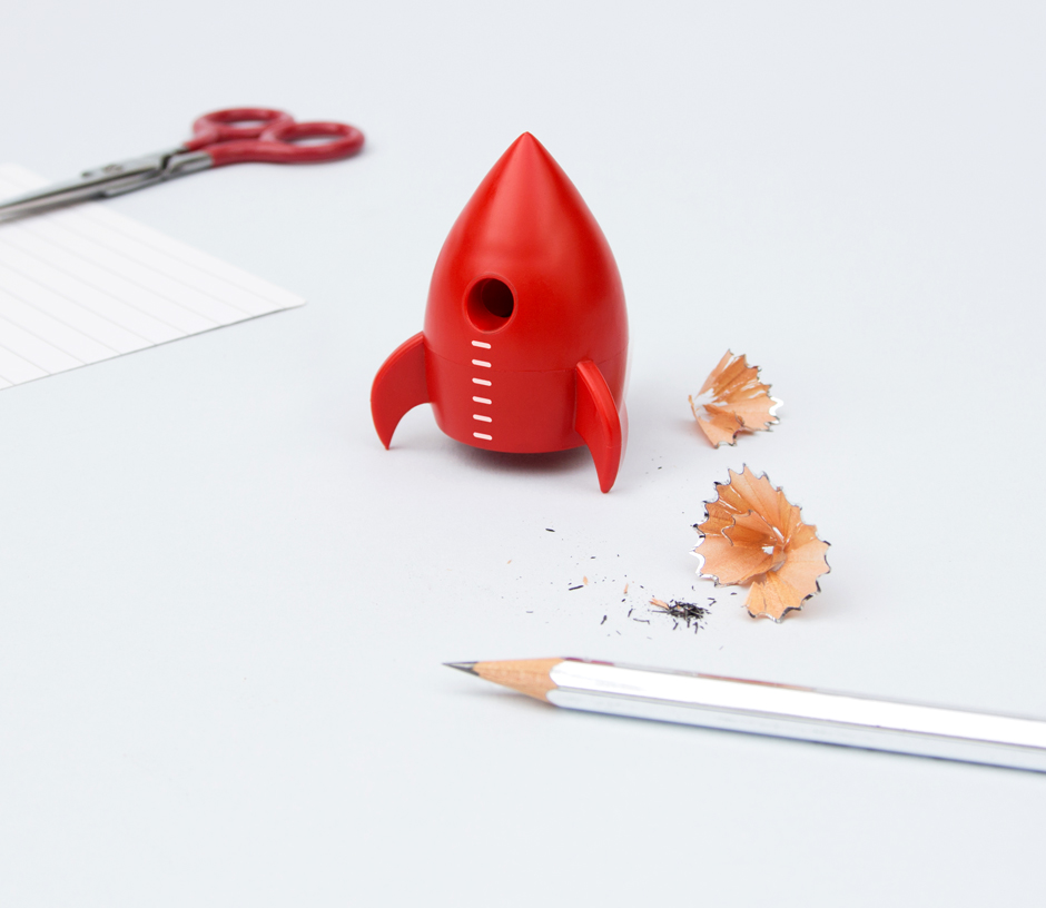 Rocket pencil sharpener on desk with silver pencil