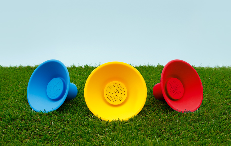 Blue, yellow and red icon speakers on grass