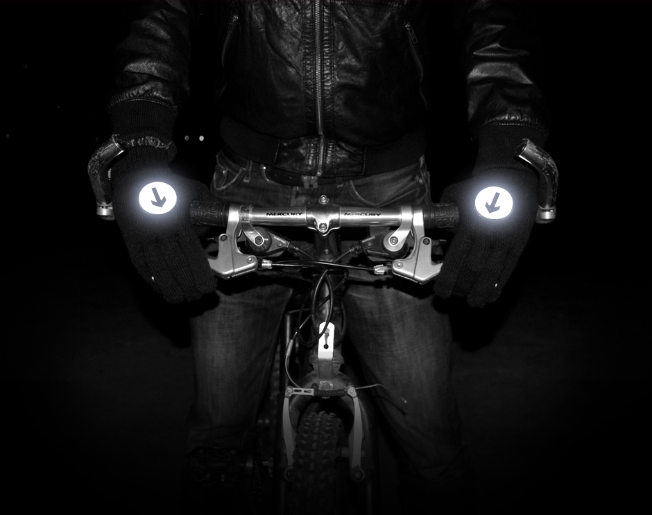 Holding bike handle bars wearing reflective biker gloves