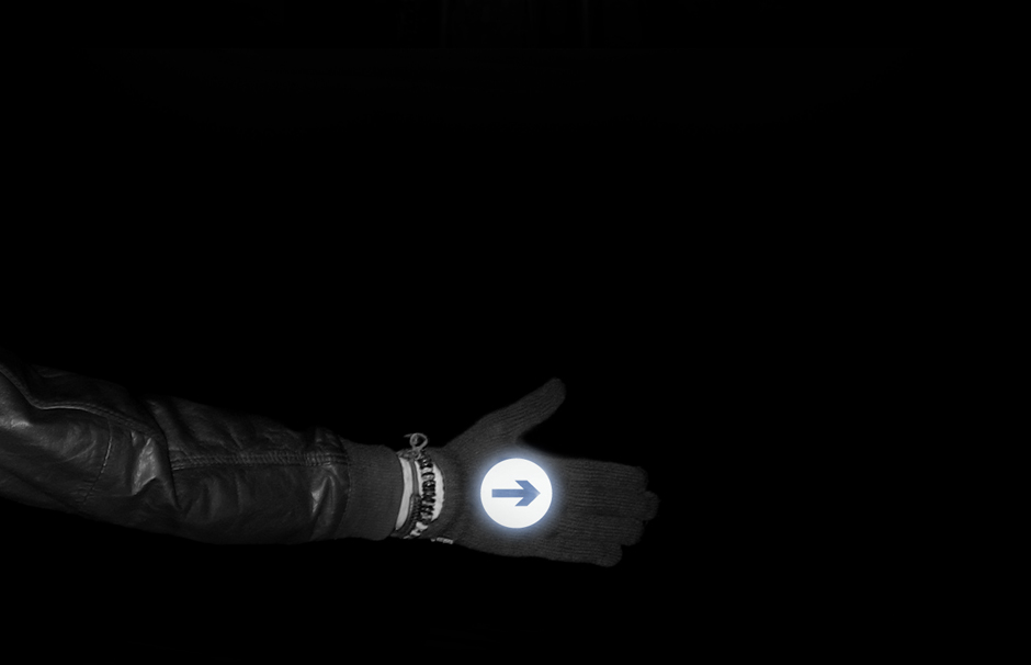 Hand indicating in reflective biker gloves at night