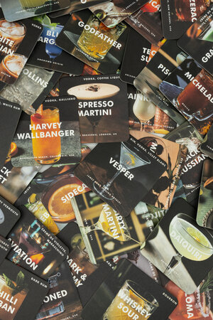 Paper coasters with cocktail recipes