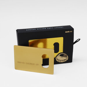 gold credit card bottle opener black box on grey background