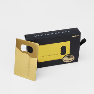 gold credit card bottle opener black box on grey background