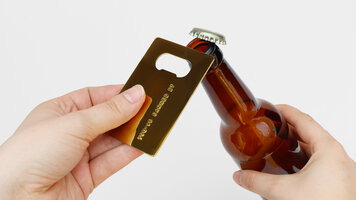 gold credit card opener hands opening beer cap