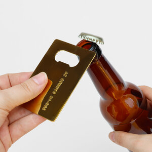 gold credit card opener hands opening beer cap