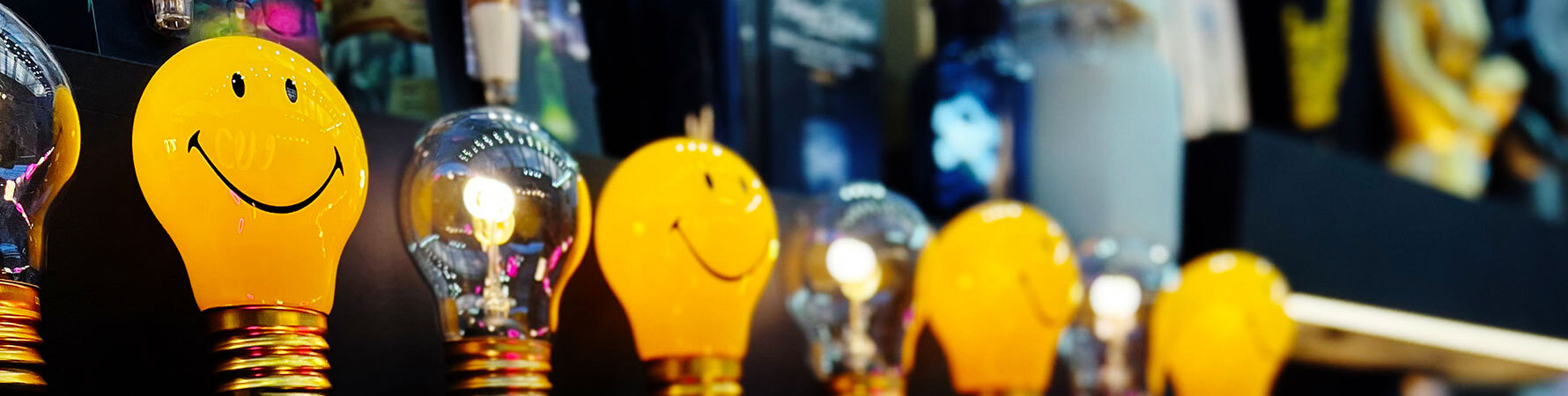 Smiley face light bulbs on display at the SuckUK Top Drawer 2025 stand – playful lighting gift ideas