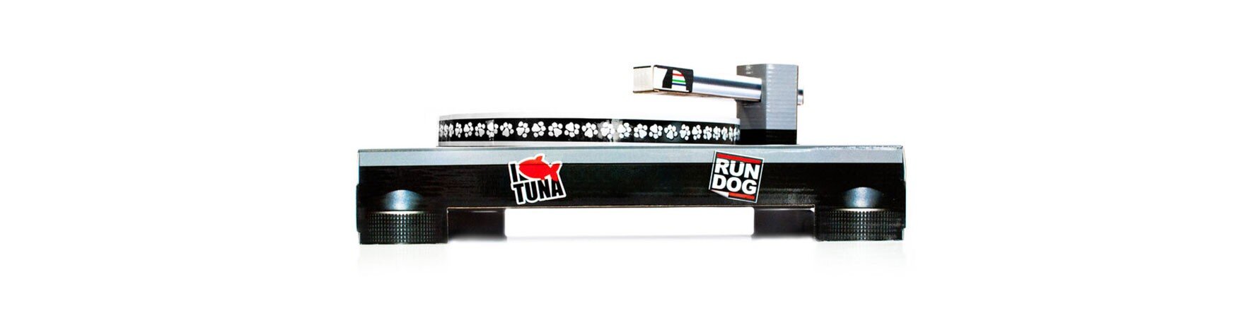 Side view of the Suck UK Cat Scratch Turntable, a cardboard DJ-style cat scratching toy featuring paw-print details and fun sticker designs.