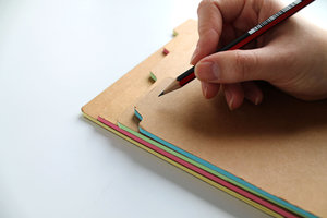 writing on notebook folder closeup