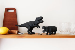 dinosaur and hippo cast iron bottle opener on shelf