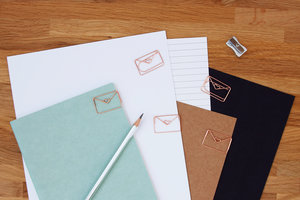 Shiny rose gold envelope paper clips