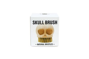 wooden skull brush in packaging