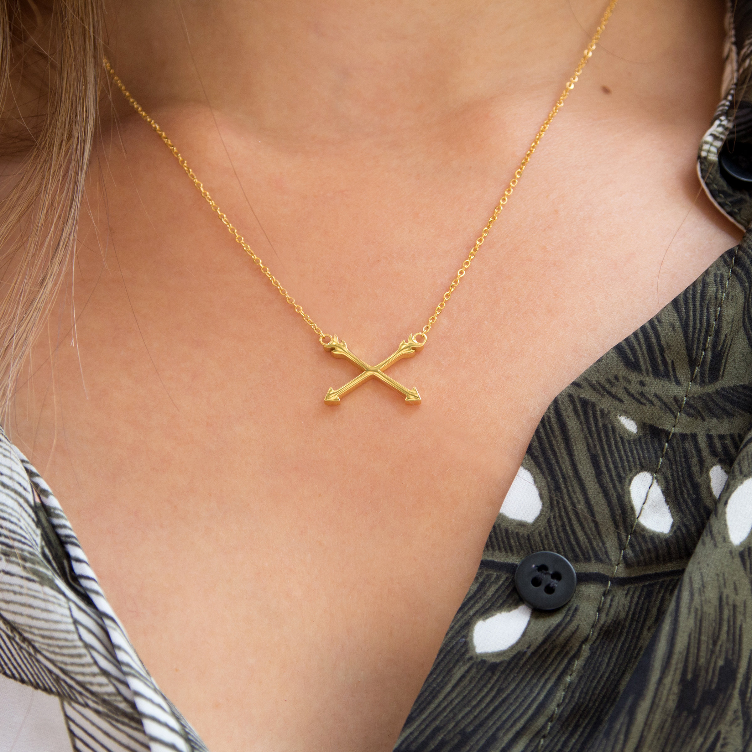 Kuku gold arrow necklace on model