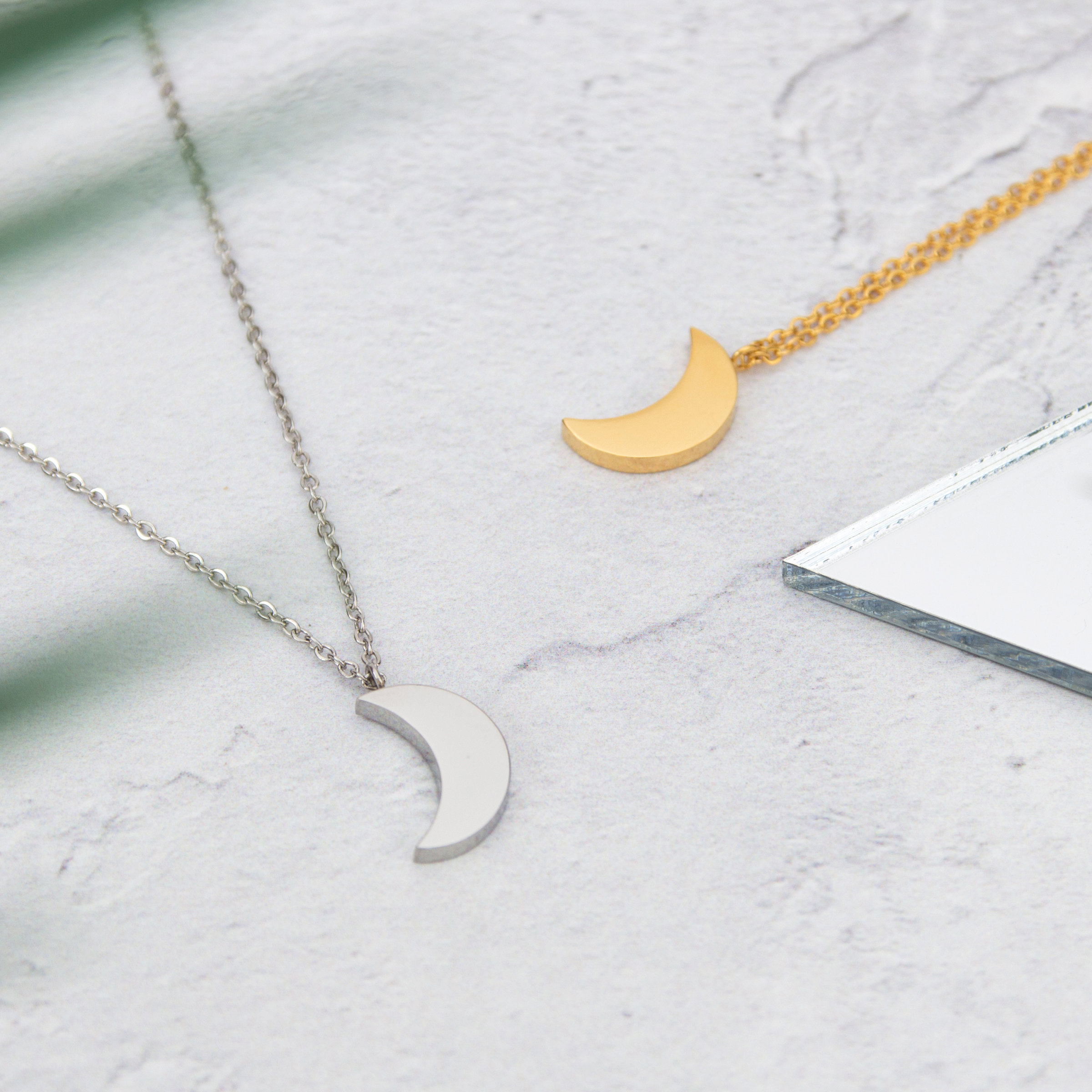 Kuku gold and silver crescent moon necklaces