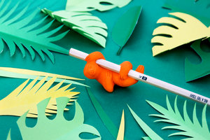 Sloth eraser on wooden pencil with paper cut leaves