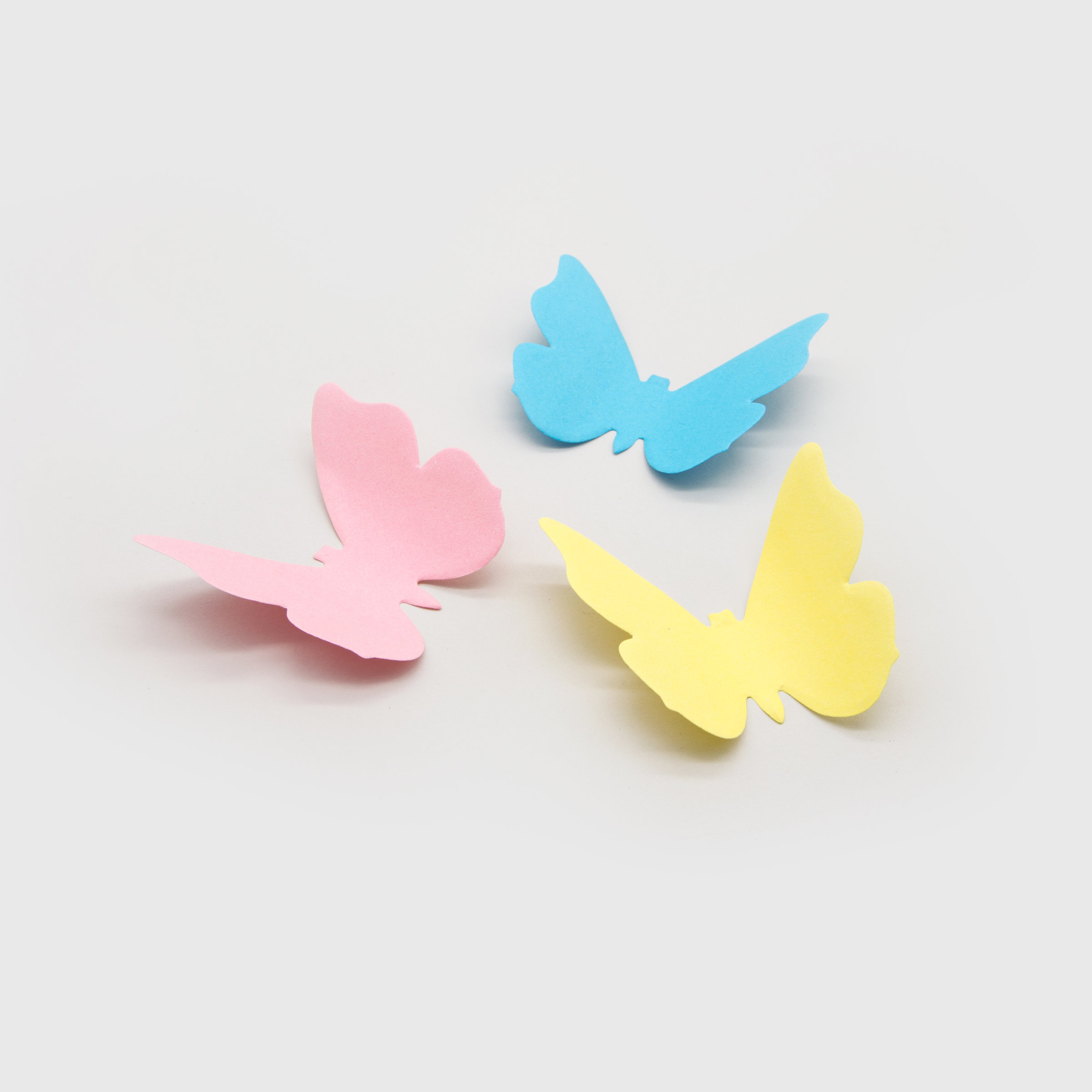 3D butterfly sticky notes in pink, blue and yellow