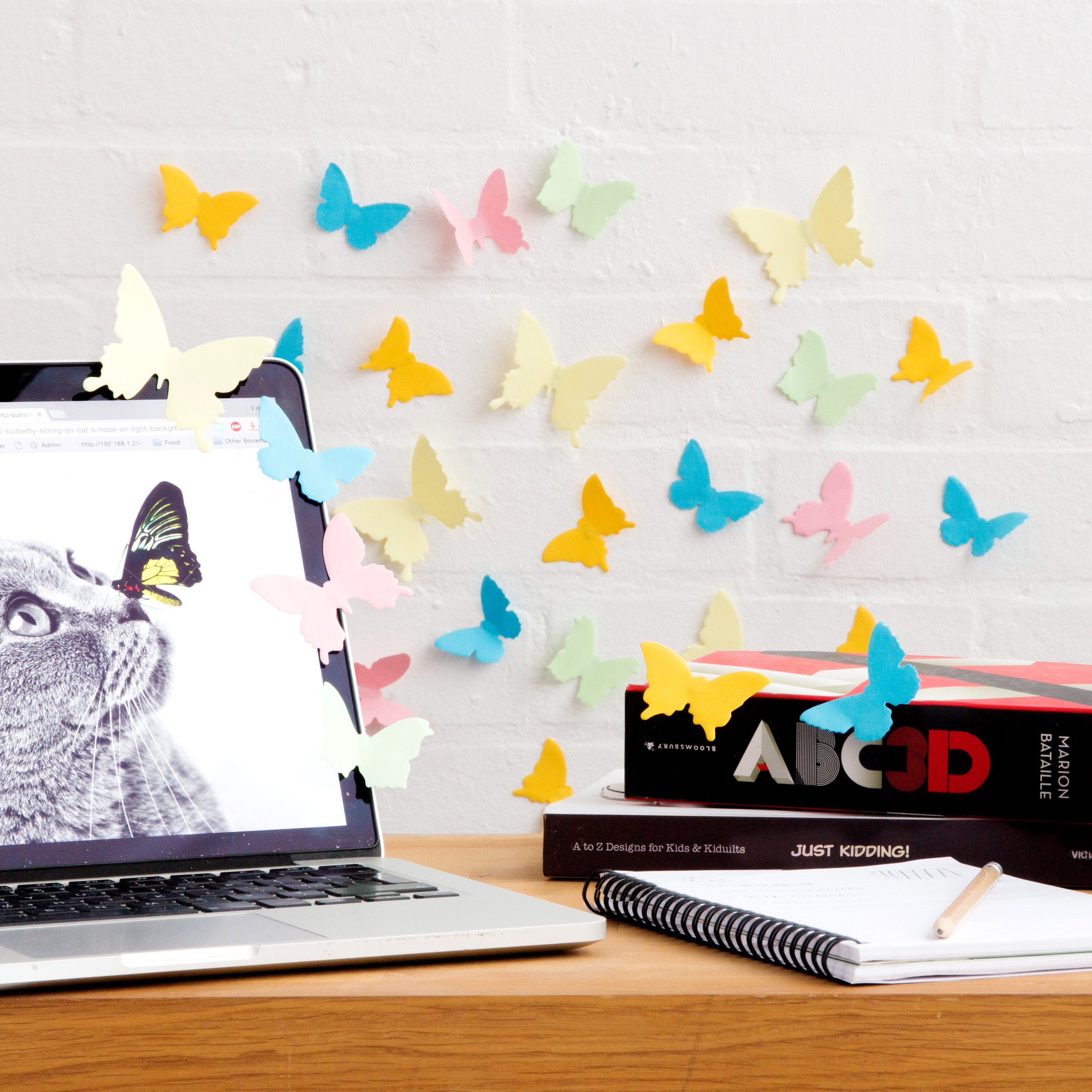 Butterfly speciemen sticky notes on desk and wall