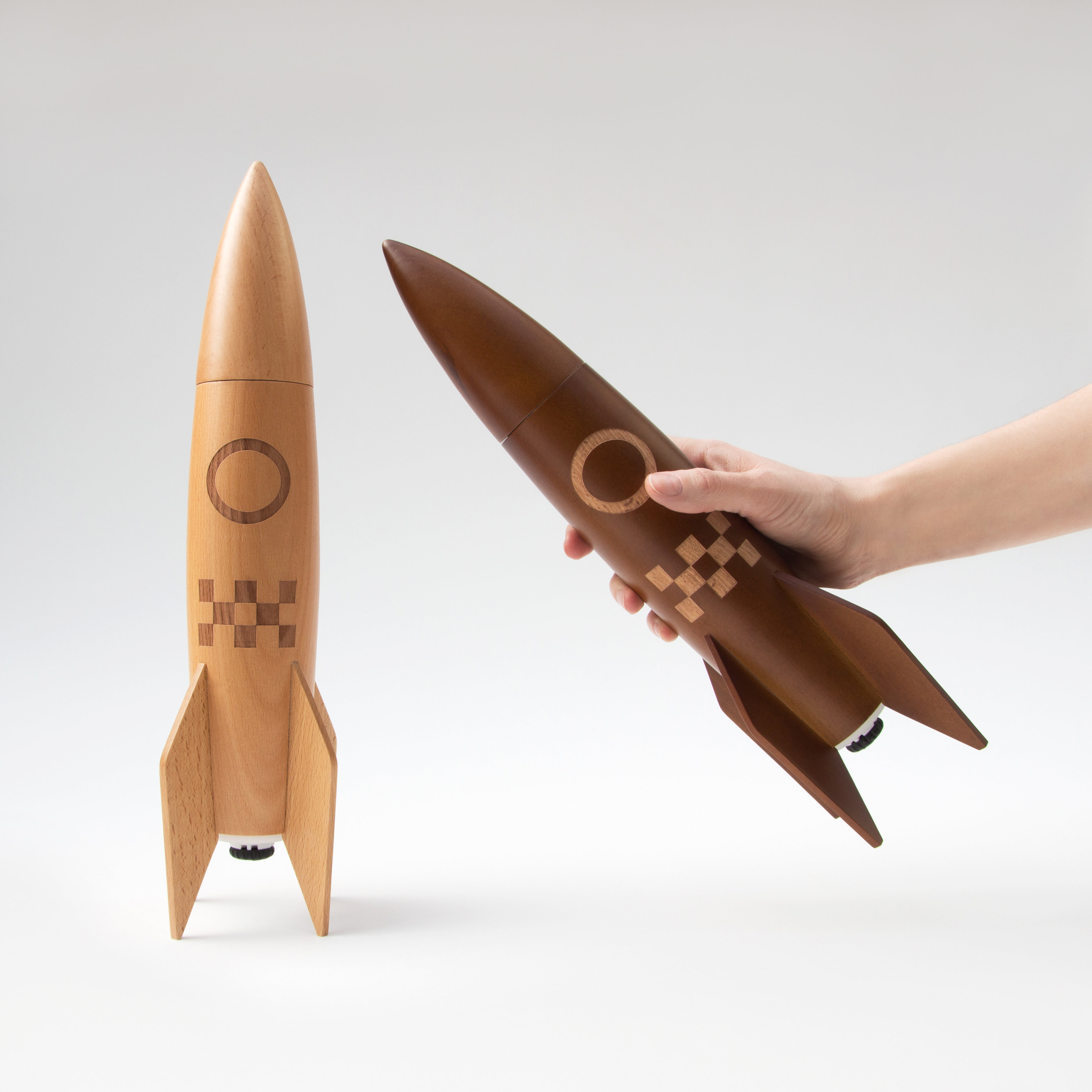 Wooden rocket salt and pepper mills with one in hand