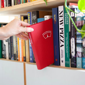 Hand taking cooks book scales from bookshelf