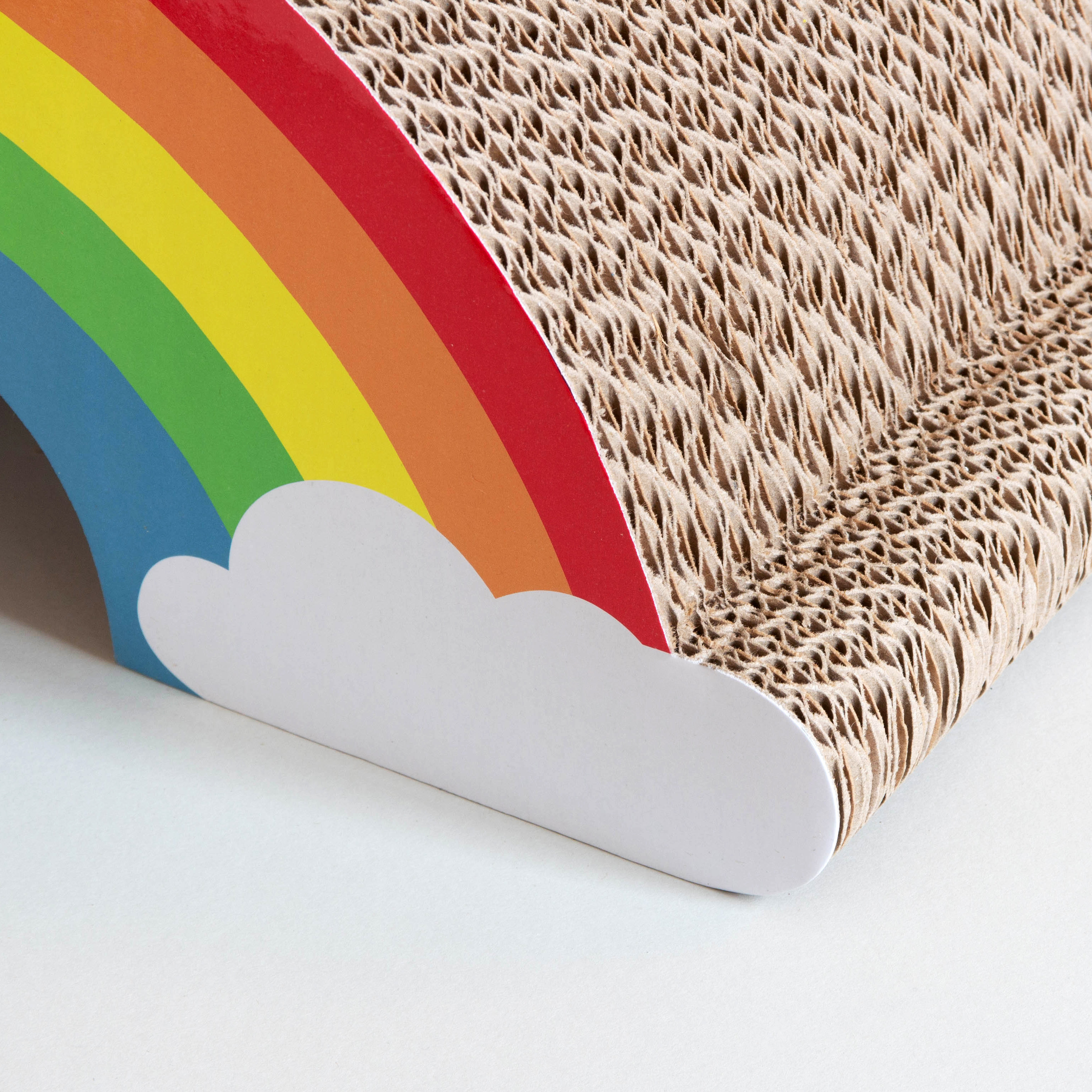 Close up cardboard cat scratching rainbow