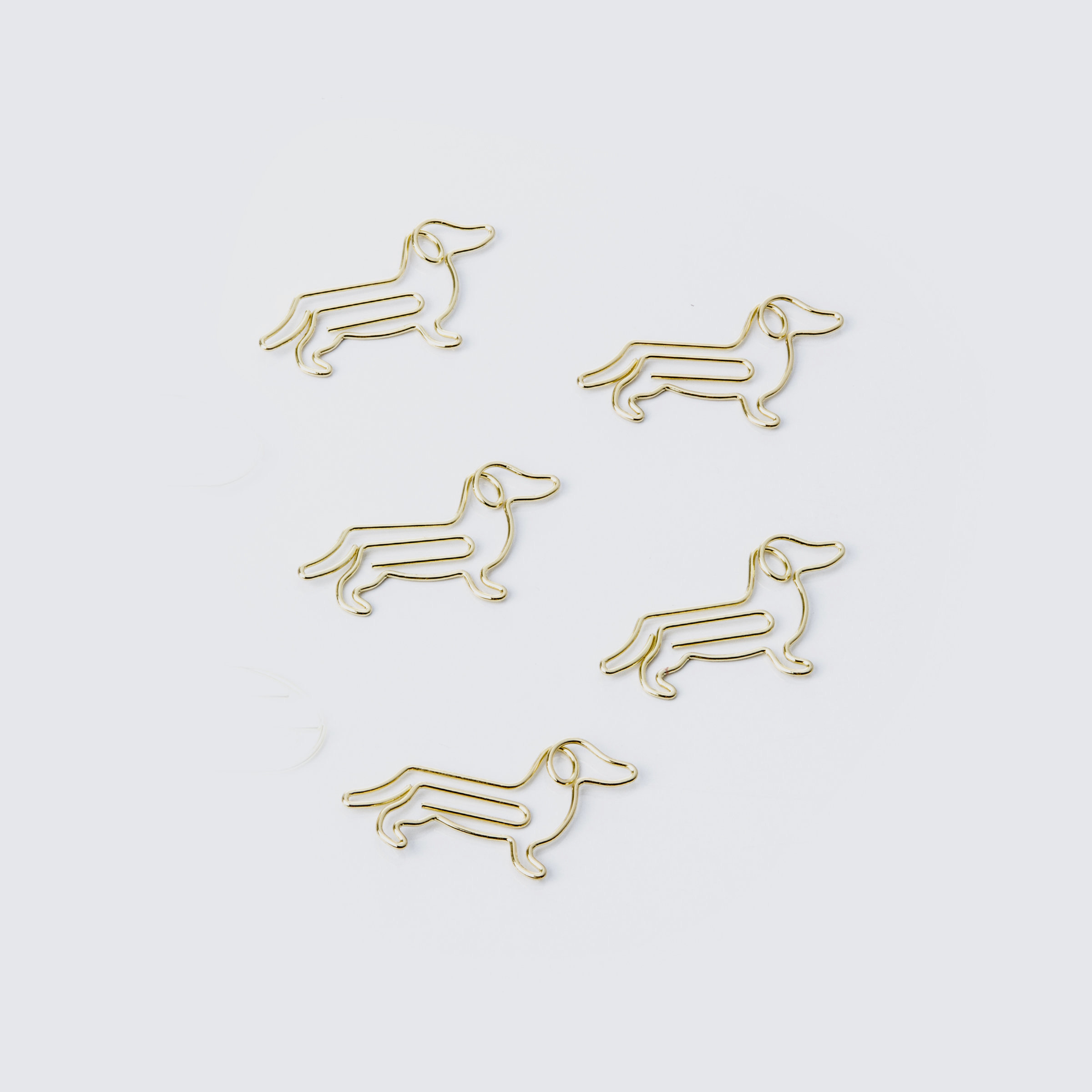 Gold dog shaped paper clips