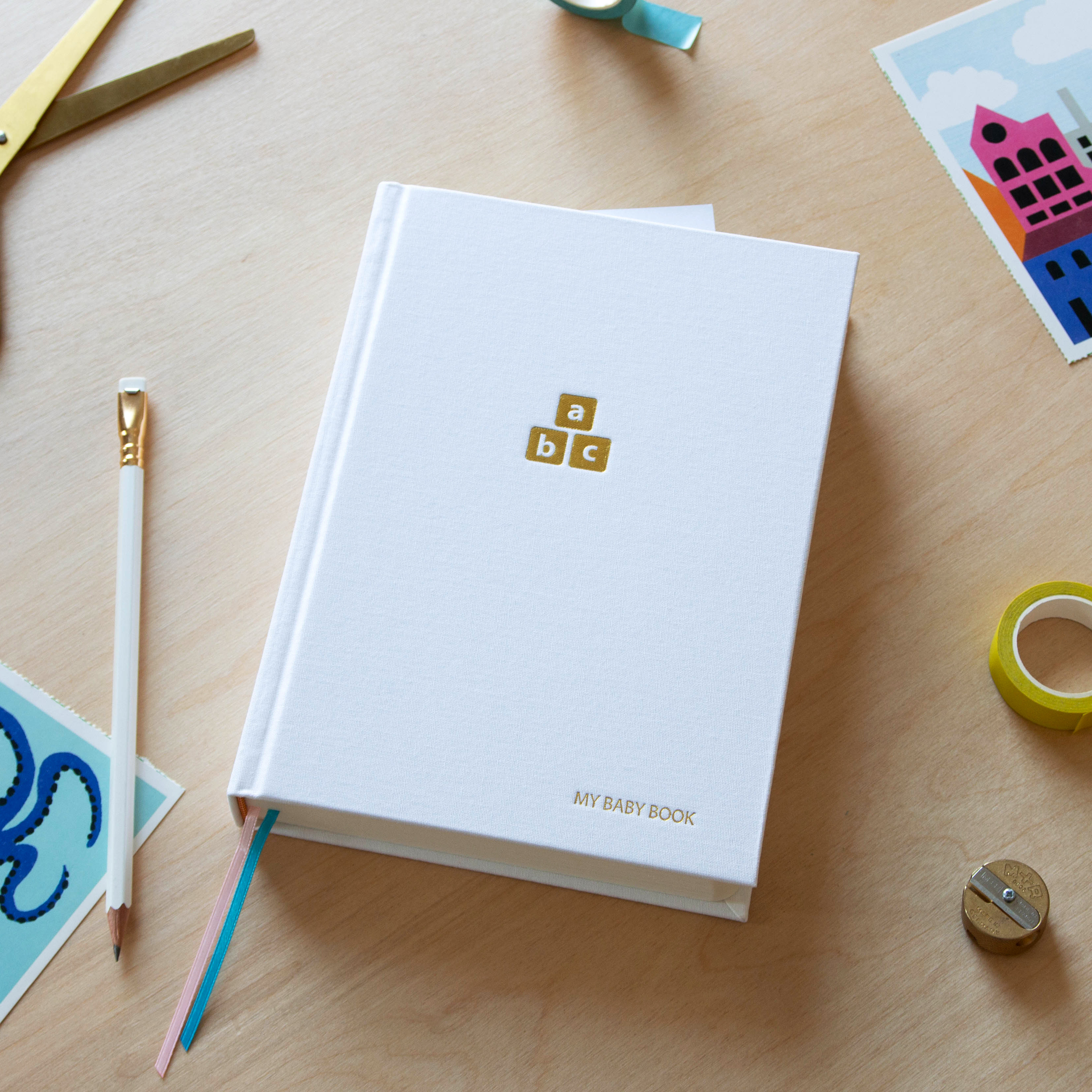 Baby book closed on desk from above