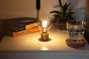 Cordless light bulb night light standing on bedside table