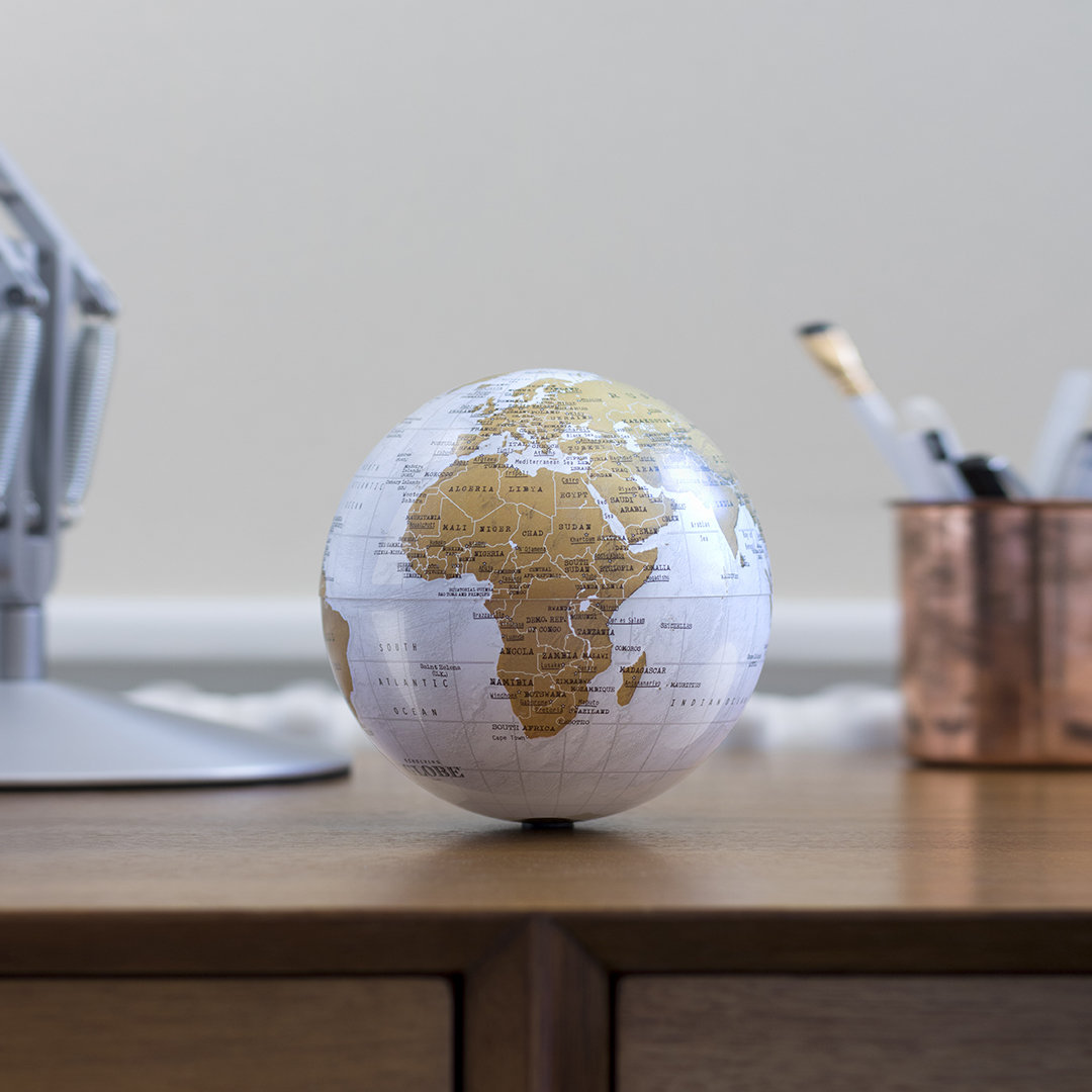 Small battery powered self-spinning globe