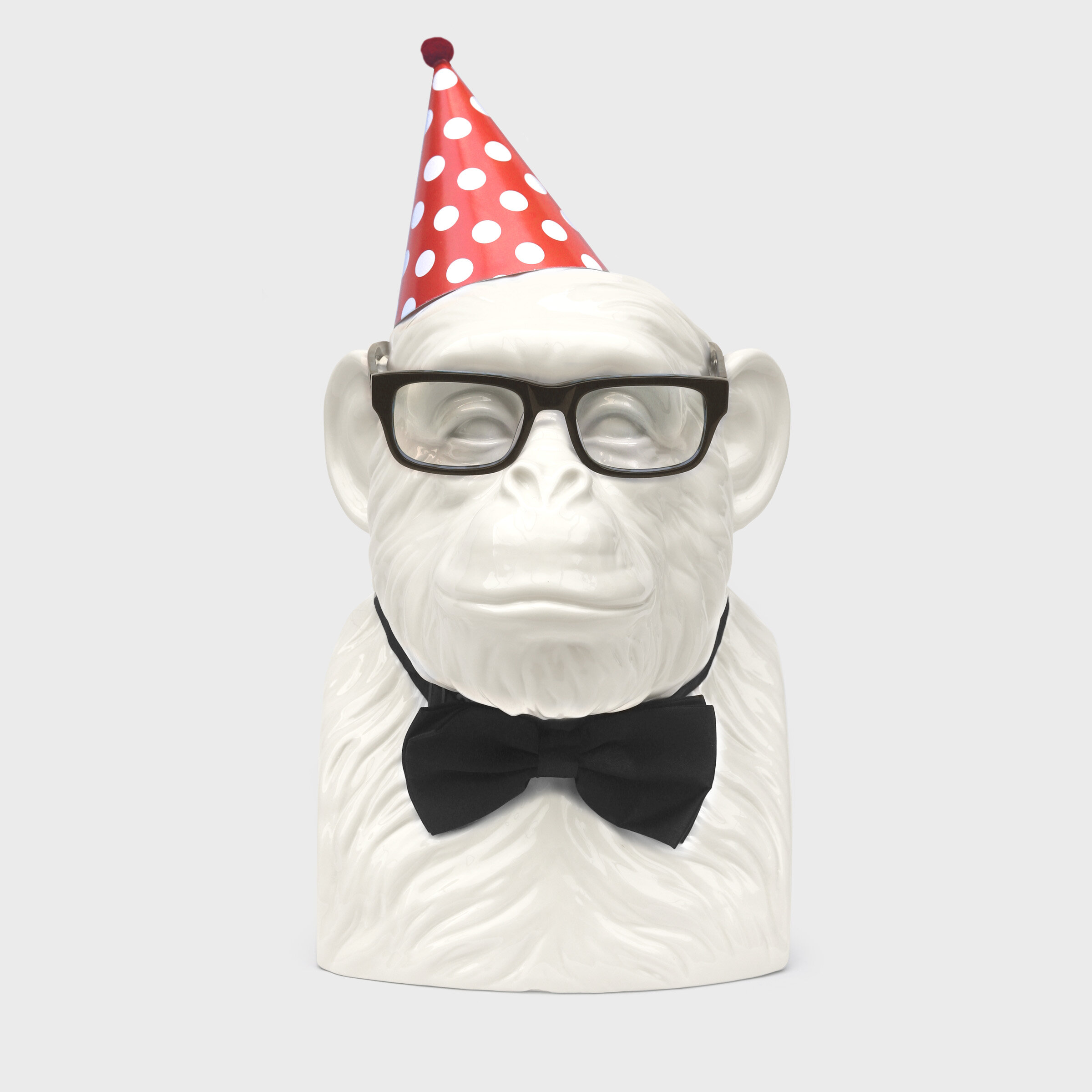 chimp with party hat and bow tie