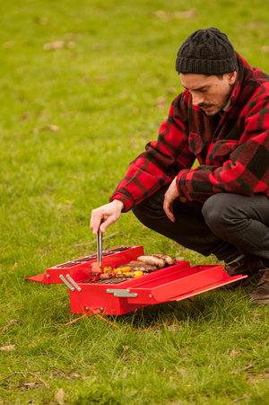 Man grilling on portable BBQ Toolbox