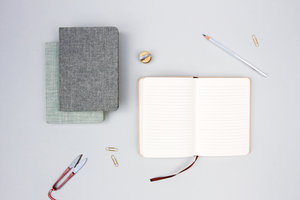 Cool linen covered notebooks on a desk