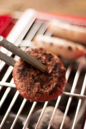 grilling burgers on portable BBQ