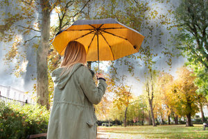 Umbrella, gold inside, black outside, stormy day