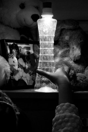 Child with Bottle Light in a fancy glass container