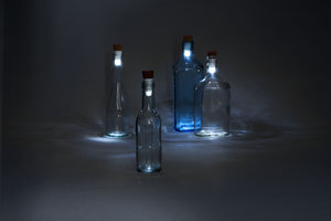 White LED Bottle Lights in empty glass bottles in the dark.