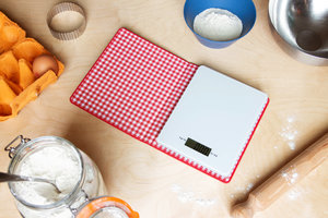 Scales concealed inside a book in kitchen