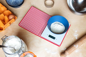 Scales inside a cookbook weighing flour