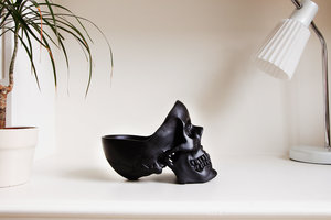 black desk skull on white table