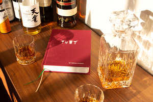 Drinks journal on a bar with whiskey