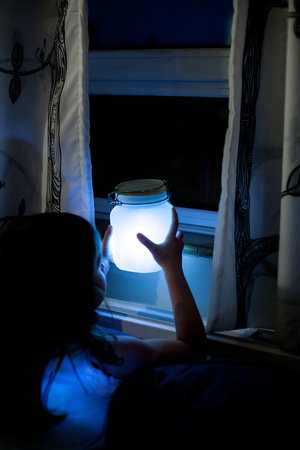 glow in the dark jar near window at night